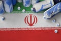 Iran flag and few used aerosol spray cans for graffiti painting. Street art culture concept