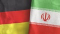 Iran and Germany two flags textile cloth 3D rendering