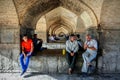 Iran, Isfahan Province, Esfahan, Khajoo Bridge, Khaju - September 2016: A group of local men resting near the arch bridge.