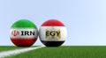 Iran vs. Egypt Soccer Match - Soccer balls in Iran and Egypt national colors on a soccer field.