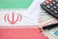 Iranian business calculations on table with iranian money and pen