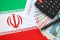 Iranian business calculations on table with iranian money and pen