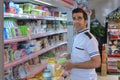 Iranian buyer standing near shelves with food in supermarket, Sh