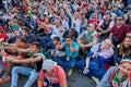 Iranian football team supporters sit in fan zone of festival.