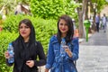 Iranian girls drink water from bottles during walk, Isfahan, Ira