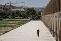 Iranian man passing by on the Si o Seh Pol bridge on the afternoon in Isfahan, Iran, Also known as Allahverdi Khan Bridge