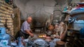 Iranian man working with copper cookware in his copper store, Yazd, Iran