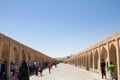 Iranian people passing by on the Si o Seh Pol bridge on the afternoon in Isfahan, Iran