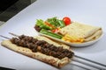 IRANIAN TIKKA boti kebab platter with salad, fries, and pita bread served in dish side view of arab food Royalty Free Stock Photo