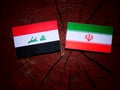 Iraqi flag with Iranian flag on a tree stump isolated Royalty Free Stock Photo