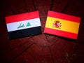 Iraqi flag with Spanish flag on a tree stump Royalty Free Stock Photo