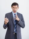 Irate. A furious businessman looking at a text message on his smartphone. Royalty Free Stock Photo