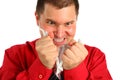 Irate man in red shirt rips sheet of paper Royalty Free Stock Photo