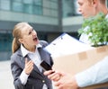 Irate woman is dismissing young manager for violating the job description