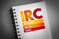 IRC - Internet Relay Chat acronym on notepad, technology concept background