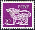 IRELAND - CIRCA 1971: A stamp printed in Ireland shows a dog from an ancient artwork, circa 1971.