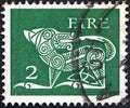 IRELAND - CIRCA 1971: A stamp printed in Ireland shows a dog from an ancient artwork, circa 1971. Royalty Free Stock Photo