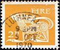 IRELAND - CIRCA 1971: A stamp printed in Ireland shows a dog from an ancient artwork, circa 1971. Royalty Free Stock Photo