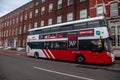 Ireland. Cork. An urban bus runs along the north bank of the River Lee, in front of the CEC, Cork English College