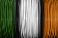 Ireland flag of the coils for 3D printer. Filament for 3d printing, Bright thermoplastic of green, white and orange Royalty Free Stock Photo