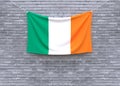 Ireland flag hanging on brick wall