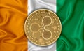 Ireland flag, ripple gold coin on flag background. The concept of blockchain, bitcoin, currency decentralization in the country.