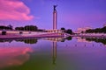 Irian Jaya Liberation Monument, Jakarta in the sunrise with reflection of cloudy sky on water Royalty Free Stock Photo