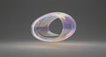 Iridescent abstract torus shape floating in gray space Royalty Free Stock Photo