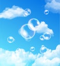 Iridescent bubbles floating against blue sky Royalty Free Stock Photo