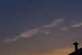 Iridescent cloud on sky at twilight with orange color of sunray. Royalty Free Stock Photo