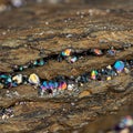 Iridescent crystals embedded within layered rock formations showcase a spectrum of Royalty Free Stock Photo
