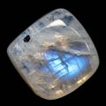 Iridescent moonstone with a polished, translucent surface and a notable blue sheen. Royalty Free Stock Photo