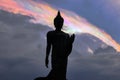 Iridescent pileus cap clouds and Buddha statue at PhutthamonthonBuddhist park in Phutthamonthon district,Nakhon Pathom Province o