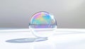 Iridescent Soap Bubble Reflecting Light on a White Surface Royalty Free Stock Photo