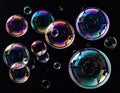 Iridescent Soap Bubbles Floating Against a Solid Black Background In Studio Shot Royalty Free Stock Photo