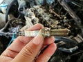 Iridium car spark plug in the mechanic hand