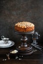 Irish apple pie with almond flakes on a wooden stand.