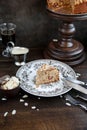 Irish apple pie with almond flakes on a wooden stand.