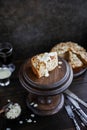 Irish apple pie with almond flakes on a wooden stand.