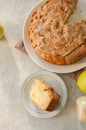 Irish apple pie on a white plate with vanilla custard sauce. Festive dessert for St.Patricks Day.