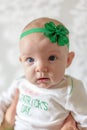 Irish baby with blue eyes wearing St Patrick`s Day outfit