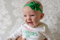 Irish baby with blue eyes wearing St Patrick`s Day outfit