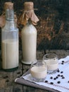 Irish coffee cream liqueur Baileys in glass and botle on wooden background. Royalty Free Stock Photo