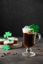 Irish coffee in glass cup and cupcakes for St Patrick s Day. Royalty Free Stock Photo