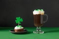 Irish coffee in glass cup and special cupcake for St Patrick s Day. Royalty Free Stock Photo