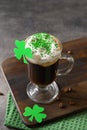 Irish coffee in green cup and special cupcakes for St Patrick s Day. Royalty Free Stock Photo