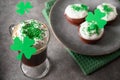 Irish coffee in green cup and special cupcakes for St Patrick s Day. Royalty Free Stock Photo