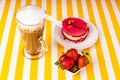 An Irish Cup of coffee, a raspberry cake, fresh sweet strawberries on a striped white and yellow background. Royalty Free Stock Photo