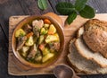 Irish dinner. Beef meat stewed with potatoes, carrots and soda bread on wooden background, top view, copy space. Homemade winter Royalty Free Stock Photo
