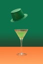 Irish festival minimal concept. Martini glass with green cocktail on terracotta table. Green glitter hats levitate above on a dark Royalty Free Stock Photo